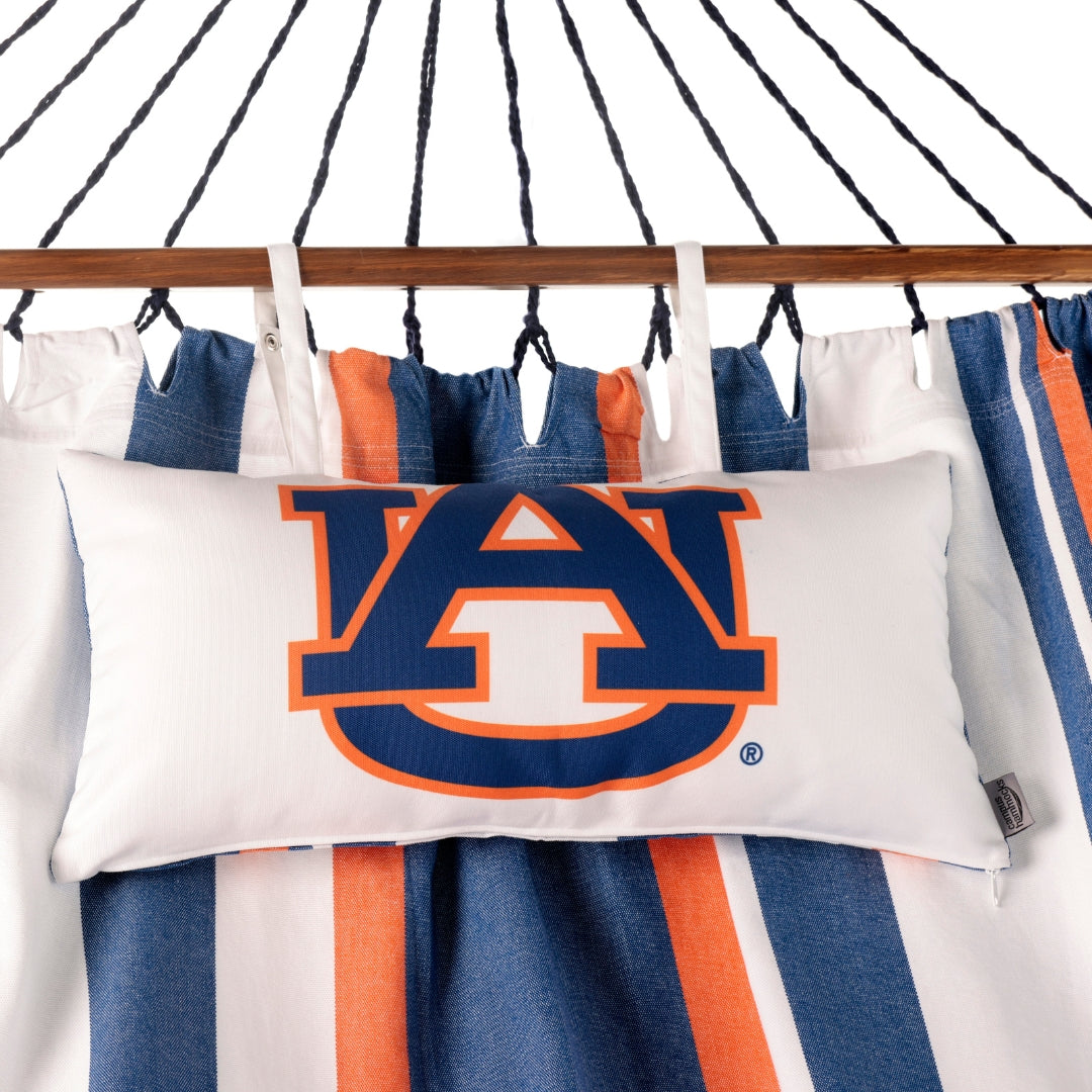 Pillow with Auburn logo on a striped fabric background