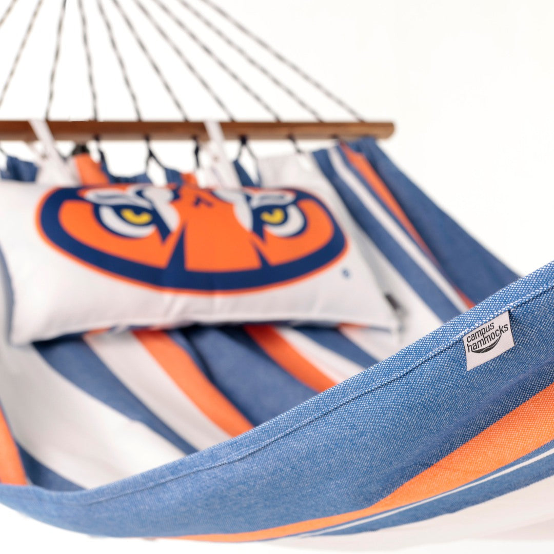 Close-up of an Auburn striped hammock with a visible Campus Hammocks brand label on a white background