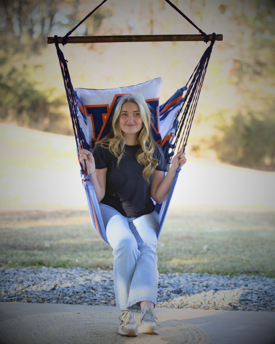 woman sitting in a hammock with The Auburn Tigers Logo