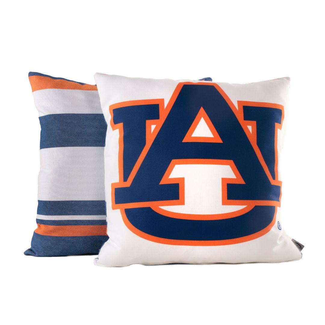 Two pillows, one with navy blue and orange stripes and the other with the AUBURN logo, on a white background.
