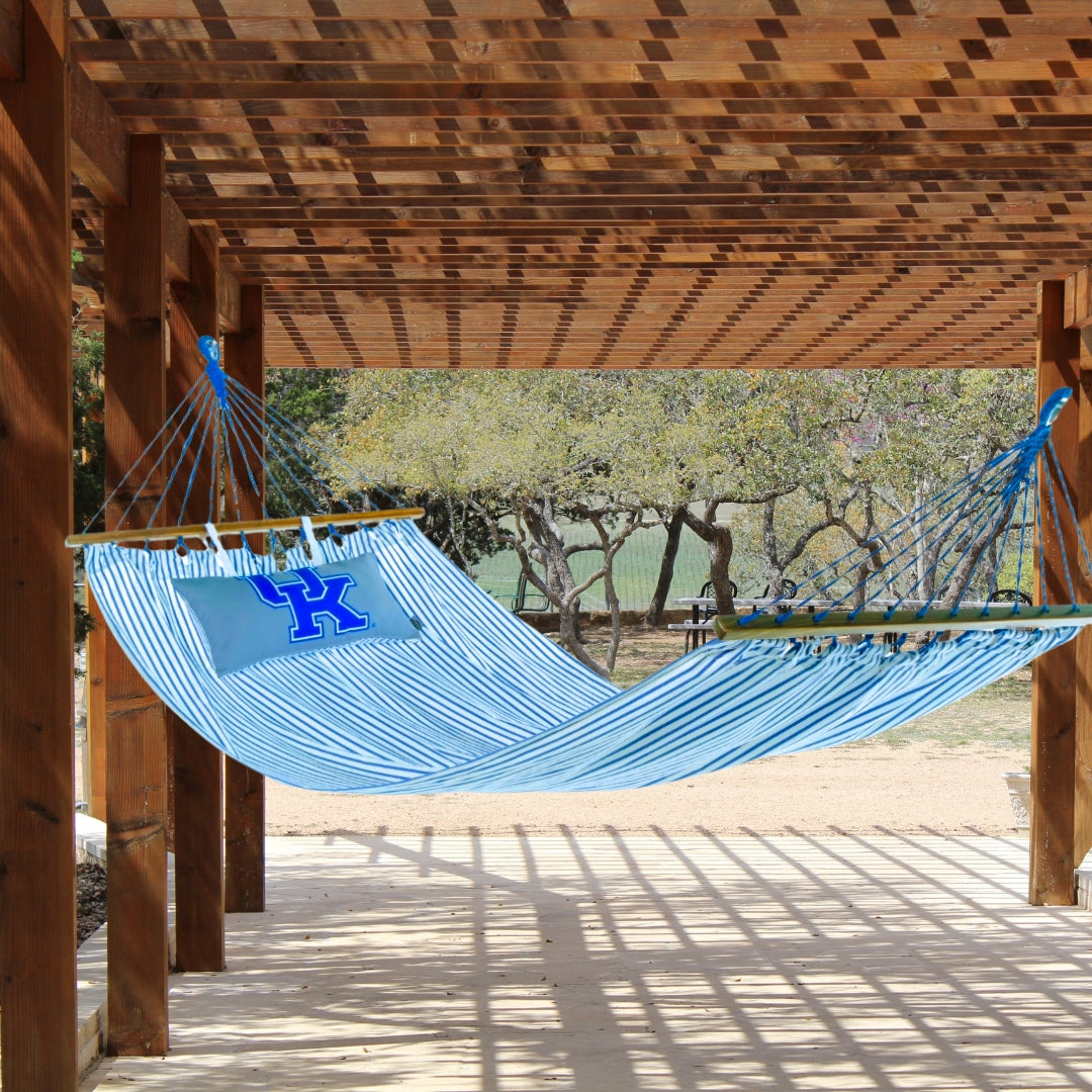 Blue hammock with a Kentucky Wildcats logo on a wooden deck
