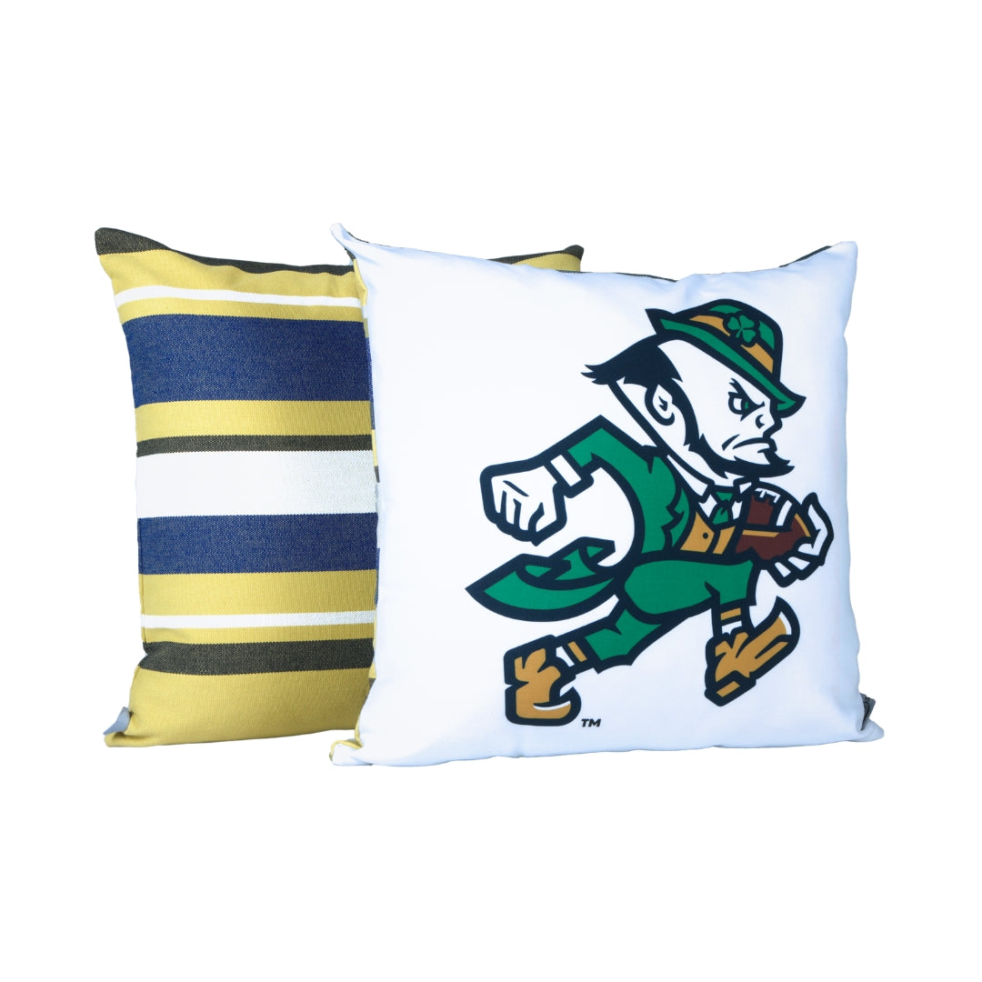 Two pillows, one striped and one with a Notre Dame Leprechaun holding a football design, on a white background
