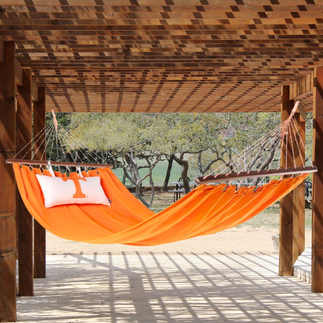 Tennessee Volunteers Orange hammock with white pillow on a patio pergola