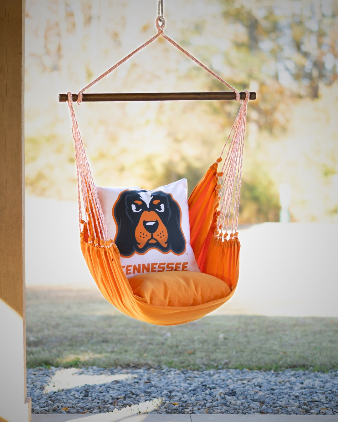 Tennessee Orange hammock chair with a pillow featuring Smokey mascot dog and 'Tennessee' text, outdoors porch 