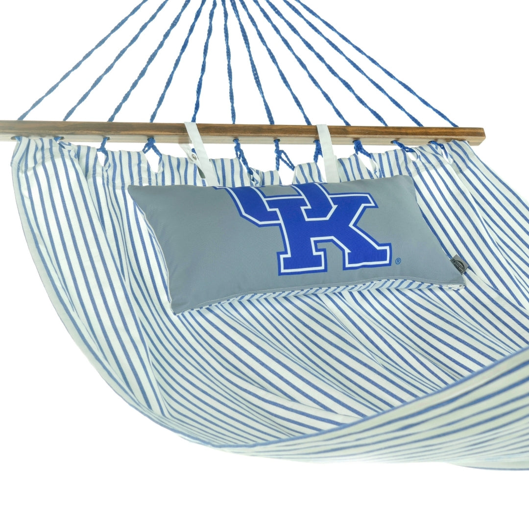 Striped hammock with a pillow featuring a large blue UK Kentucky logo on a white background