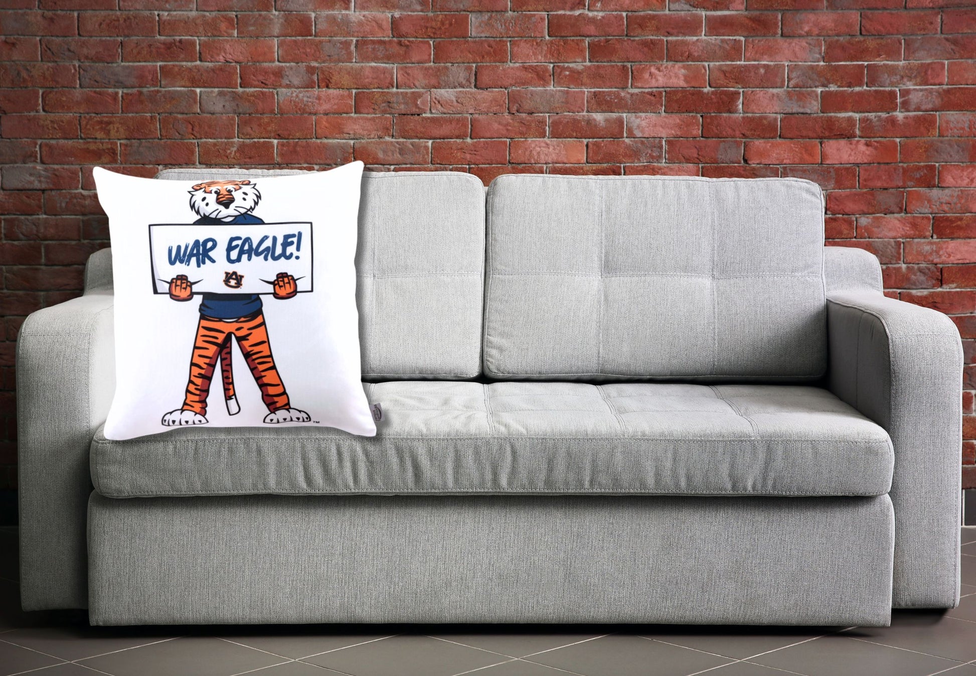 auburn tigers war eagle throw pillow on a gray sofa 