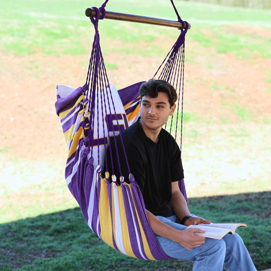 guy sitting on a lsu chair hammock outdoors