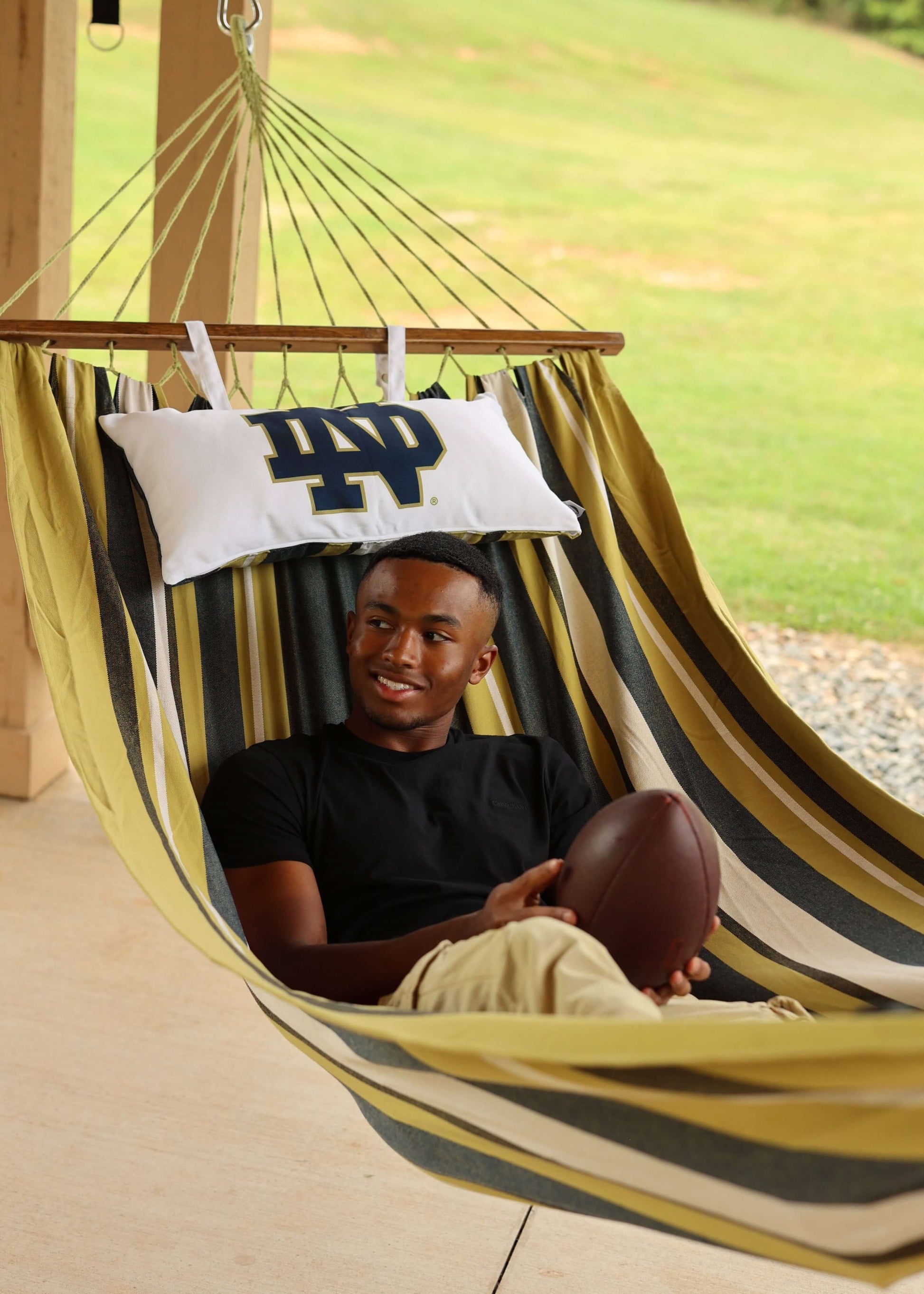 man on a notre dame hammock outdoors tailgate
